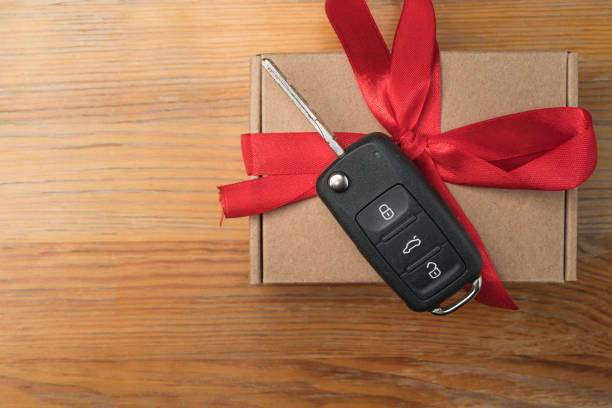 istock Car key on a paper box with red bow. 1192863789