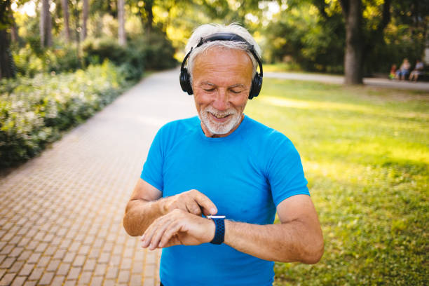 istock Senior man using smart watch while exercising outdoors 1192865431