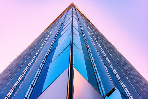 An urban downtown skyscraper shot at the corner from below at dusk in downtown Austin, Texas.