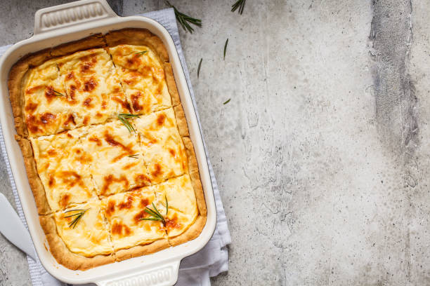 istock Cheese pie with rosemary in the oven dish, gray background. Top view, copy space. 1192866891