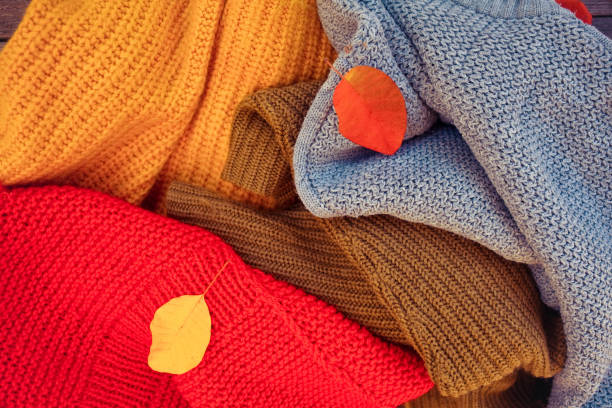 istock A pile of different-colored knitted things and autumn leaves. 1192866971