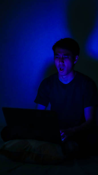 istock Asian Millennials Playing Game In The Dark Room Blue Background 1192867853