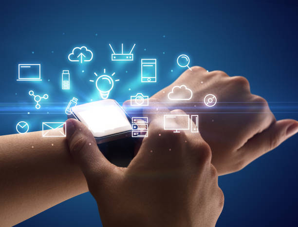 istock Hand wearing smartwatch with multimedia symbols 1192868110