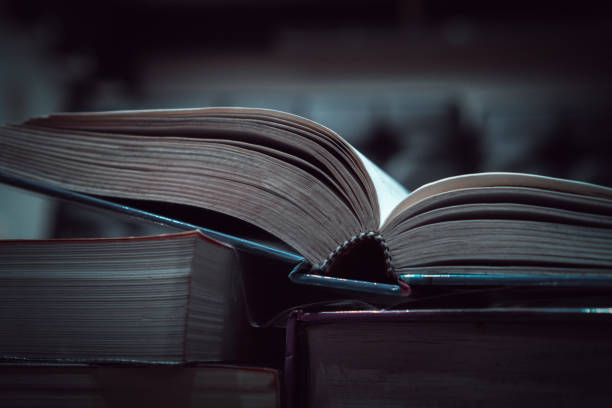istock Stack of book for education learning in textbook literature at academic on reading desk in library school study classroom. Cognitive knowledge studying information in university. Classic tone 1192870535
