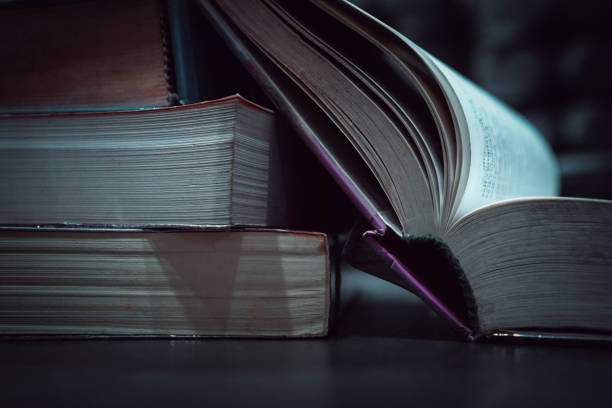 istock Stack of book for education learning in textbook literature at academic on reading desk in library school study classroom. Cognitive knowledge studying information in university. Classic tone 1192870737