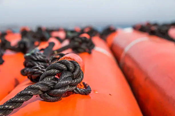 Photo of Closeup of the rope on life boats on a ship