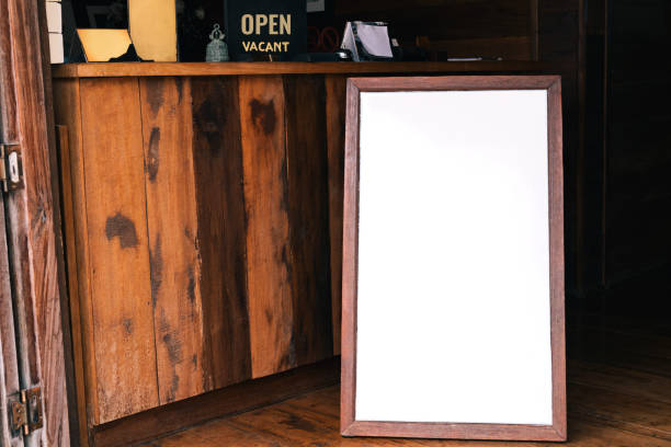 istock Mock up white Label blank advertising billboard for wood frame front restaurant cafe at hotel on old wooden background display your product insert  text. retro vintage decoration style 1192870856