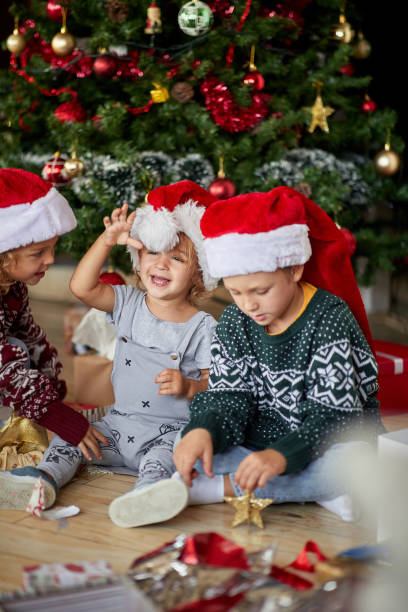 istock happy  boys in Santa hat at Christmas. 1192872186