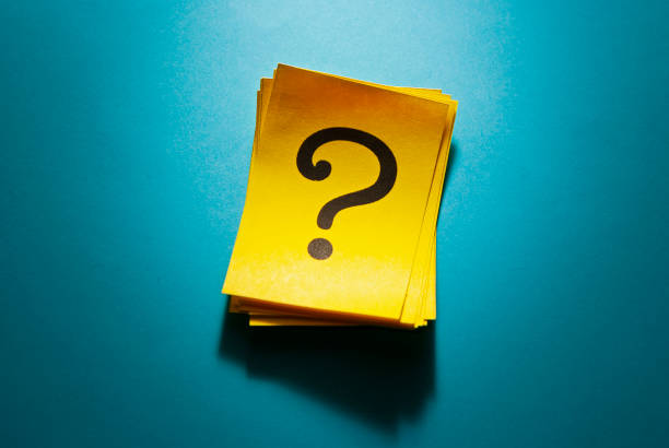 istock Stack of colorful yellow cards with question mark 1192875494