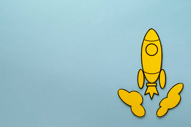 istock Yellow cartoon rocket zooming through space 1192875587