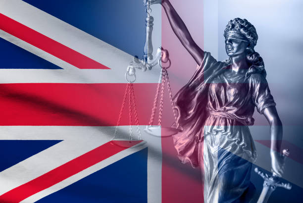 istock Statue of Justice over a British Union Jack flag 1192875660