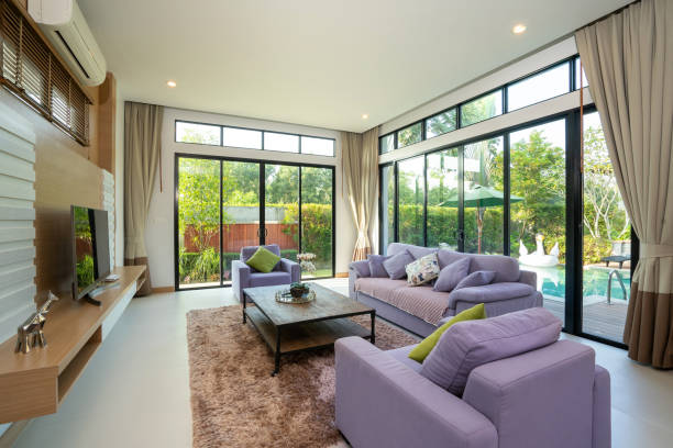 istock Spacious living room with pool view and purple couch 1192875770