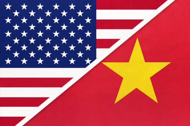 istock USA vs Vietnam national flag from textile. Relationship between two american and asian countries. 1192876339