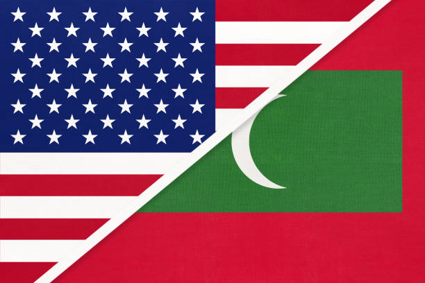 istock USA vs Republic of Maldives national flag from textile. Relationship between two american and asian countries. 1192877591