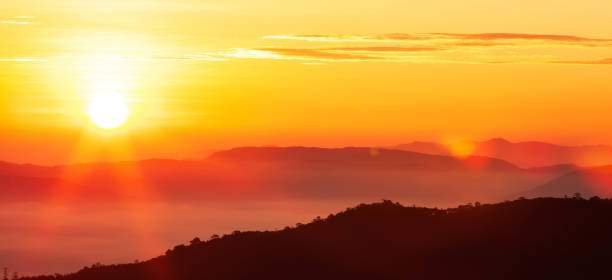istock Glowing sunrise shines over mountain range. 1192879404