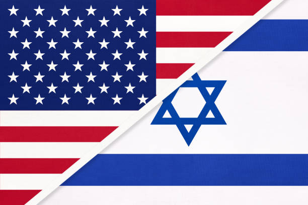 istock USA vs Israel national flag from textile. Relationship between two american and asian countries. 1192880573