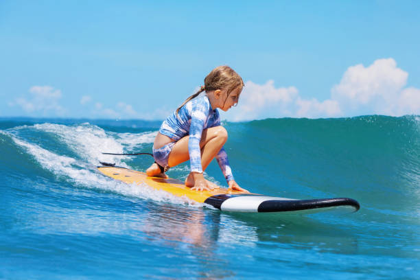 istock Young surfer rides on surfboard with fun on sea waves 1192883127