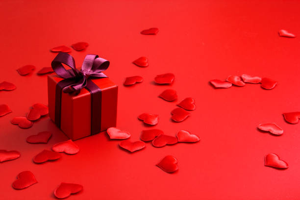 istock Red gift box with hearts on red background 1192883842