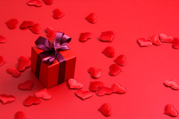 istock Red gift box with hearts on red background 1192883902
