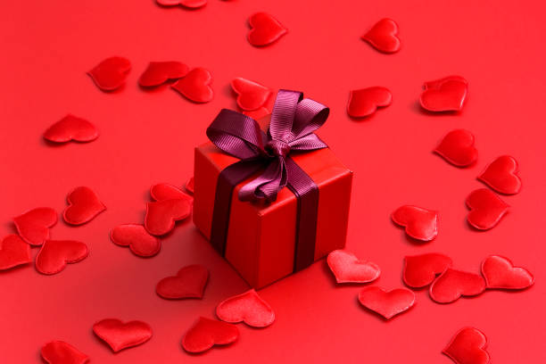 istock Red gift box with hearts on red background 1192884072