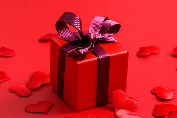 istock Red gift box with hearts on red background 1192884243