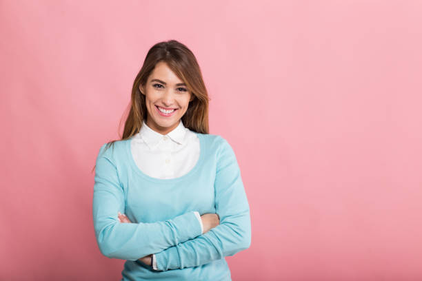 Happy young woman standing in front of photo camera
