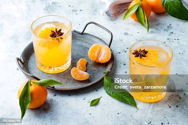 Spicy Winter Yellow Orange Cocktail Or Mocktail With Fresh Tangerines And Anise On Grey Background Christmas And New Year Holiday Welcome Drink Copy Space Stock Photo - Download Image Now