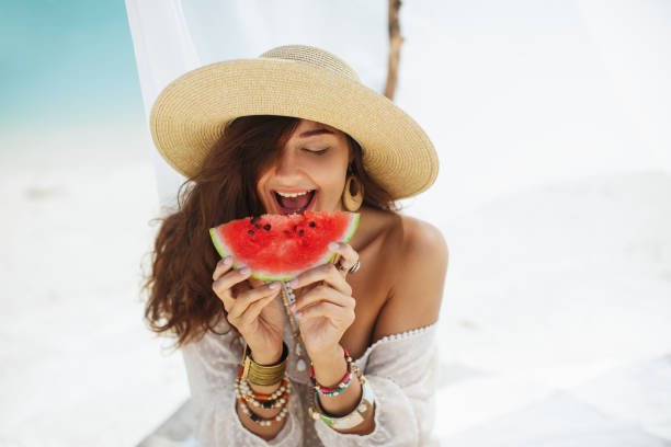 istock Woman on the Beach Eating Watermelon 1192886817