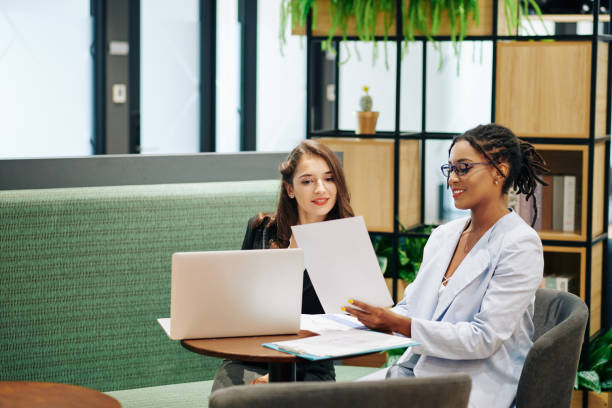 istock Business lady showing document to coworker 1192887434