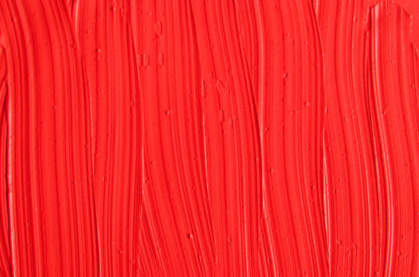 istock Red cosmetic clay (facial mask, cream) texture close up, selective focus. Bright red colour abstract background with brush strokes. 1192887480