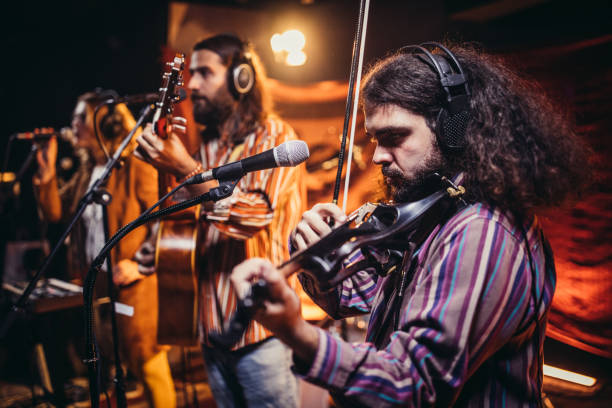 istock Man violinist performing on stage with band 1192887645