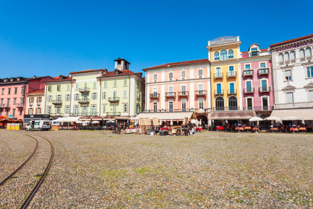 LOCARNO, SWITZERLAND - JULY 10, 2019: Street cafe and colorful houses at the Piazza Grande main square in Locarno town in Ticino canton, Switzerland