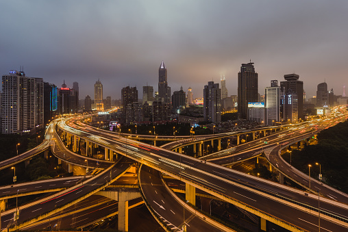 Aerial View of Overpass and City Traffic at Rush Hour, from Day to Night / Shanghai, China