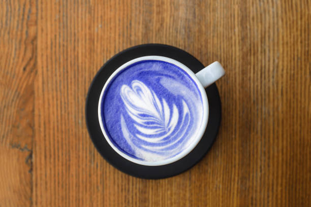 istock Blue cappuccino with art in a white cup. Top view, close up. 1192892270