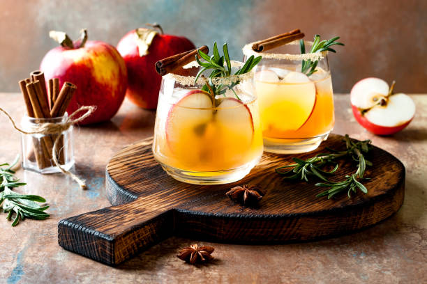 Smoky apple cider margarita fall cocktail with cinnamon, rosemary and star anise stock photo