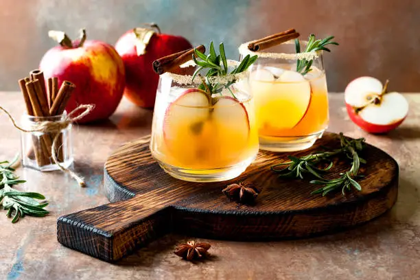 Photo of Smoky apple cider margarita fall cocktail with cinnamon, rosemary and star anise