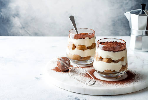 Traditional Italian dessert tiramisu in a glass.