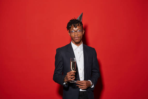 istock African Man Posing against Red at Party 1192895318