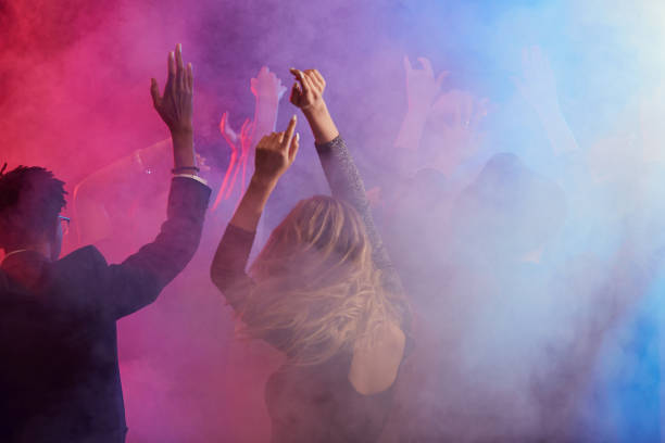 istock Dancing Crowd in Smoky Nightclub 1192895486