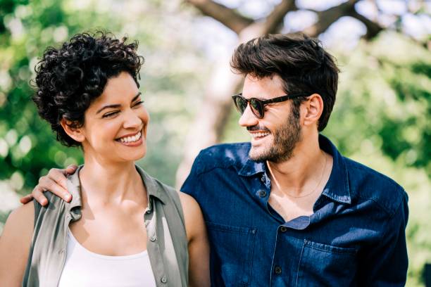 istock Happy heterosexual couple enjoying in park 1192895772