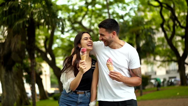 Smiling couple eating ice cream