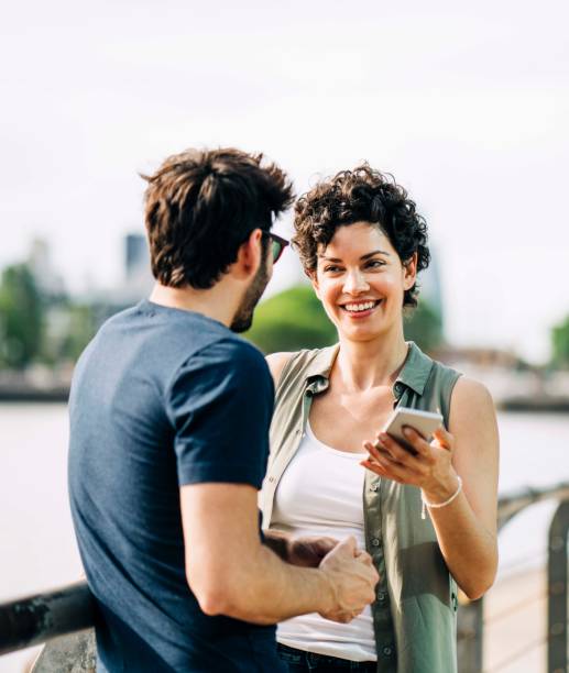 istock Smiling couple talking while standing in city 1192896036