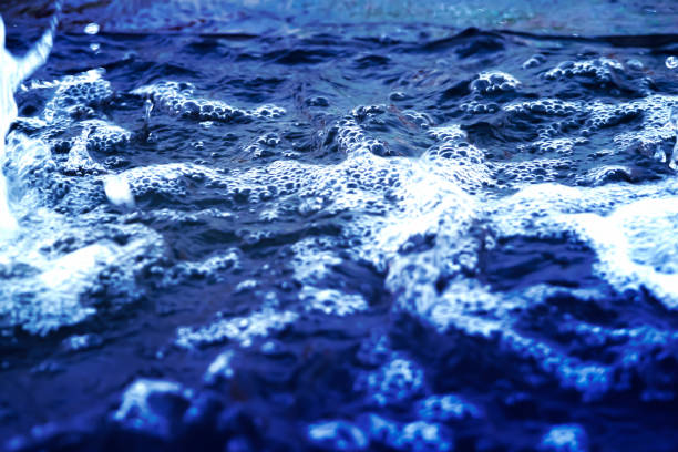 istock blurred abstract moving bubble waves ripple of pure water surface dark blue color background with beautiful glitter bokeh reflection idea design for healthy and global environmental concept 1192896274