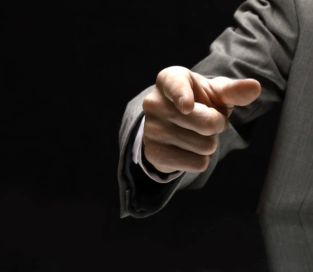 istock closeup. businessman pointing at a copy space while sitting at 1192897210