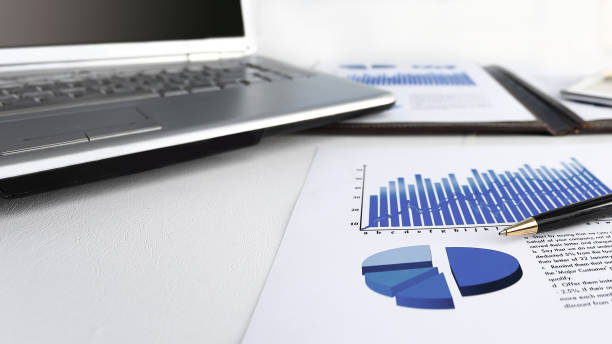 istock laptop,digital tablet with financial graph on the desktop 1192897213