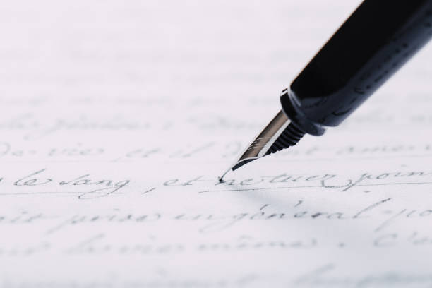 istock fountain pen on paper with ink text closeup 1192897492