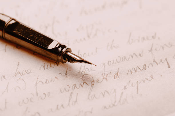 istock fountain pen on paper with ink text closeup 1192897614