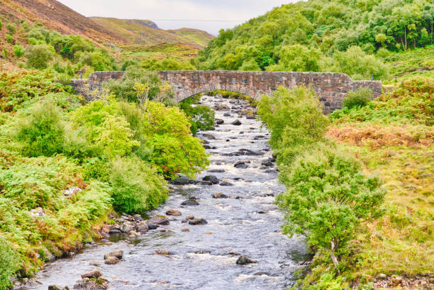 Looking at old Bridge crossing a river at the northwestern part of Scotland.