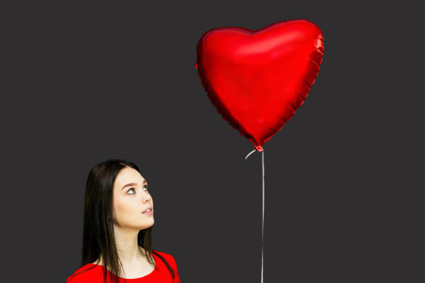 istock A girl looks at a flying balloon. 1192899237