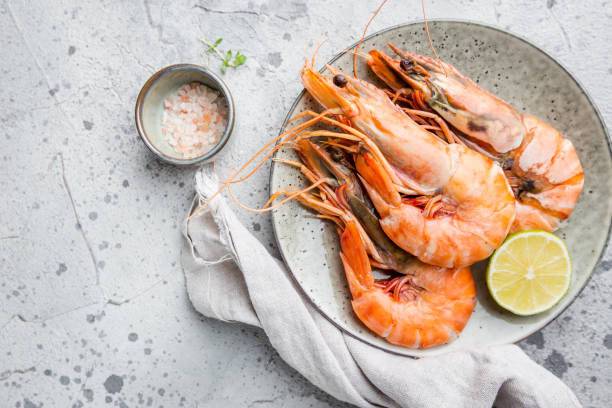 Fresh Tiger Prawns Giant fresh Tiger Prawns on plate over dark stone background, top view black tiger shrimp stock pictures, royalty-free photos & images